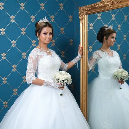 Princess-style Christian wedding dress with intricate lace details and flowing train