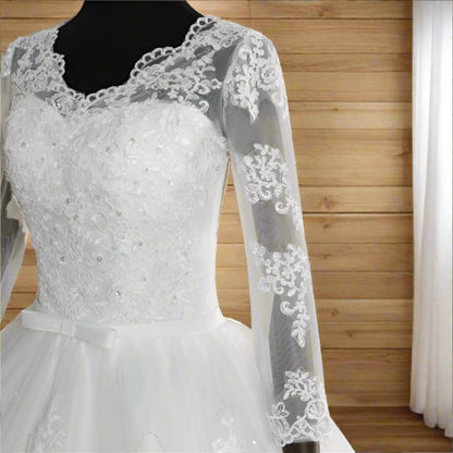 Romantic Christian bridal gown with soft tulle skirt and intricate lace appliqués