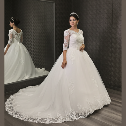 White Christian bridal gown featuring three-quarter lace sleeves and a full tulle skirt