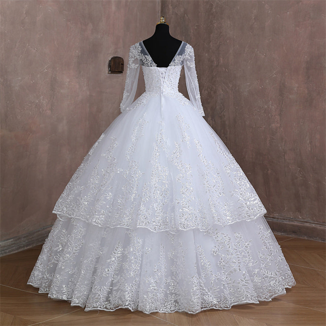 Timeless Christian bridal dress with sheer sleeves, floral lace accents, and graceful silhouette