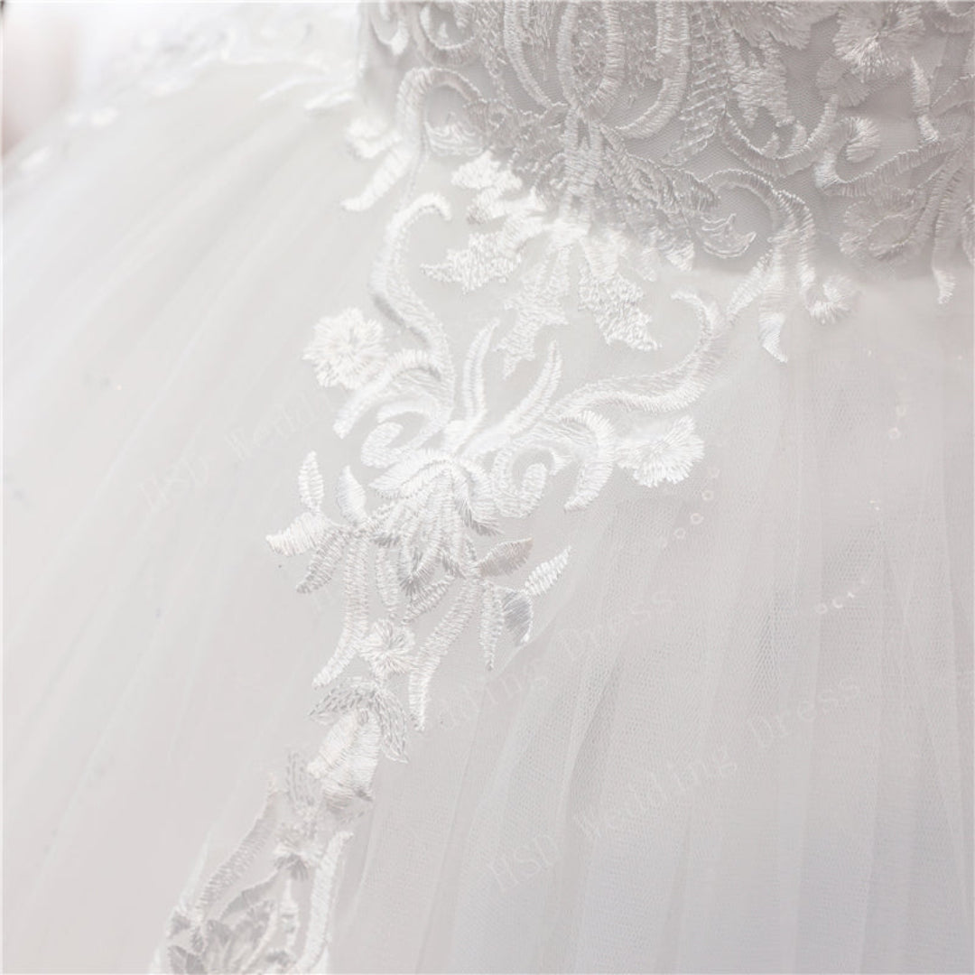 Timeless white Christian bridal gown with off-shoulder neckline and detailed lace craftsmanship