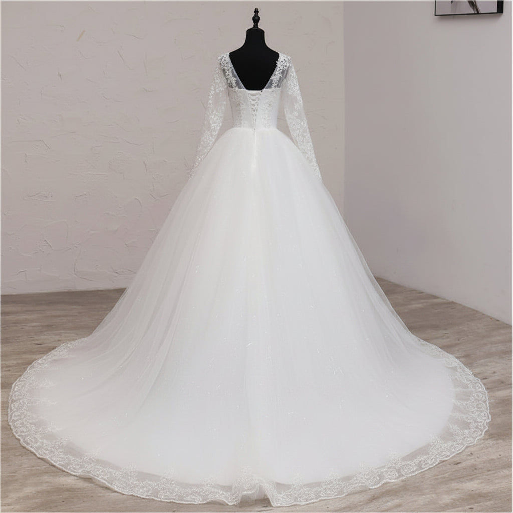 Christian wedding dress with V-neckline, sheer lace sleeves, and full tulle skirt