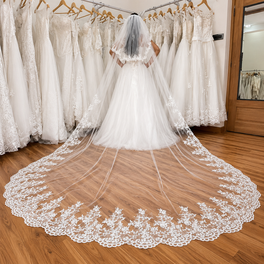 Long Christian wedding veil with embroidered lace and cathedral train.
Christian wedding veil with lace-edged blusher for church brides.