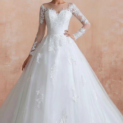 White Christian bridal ball gown featuring sheer lace sleeves and floral embroidery by GownLink