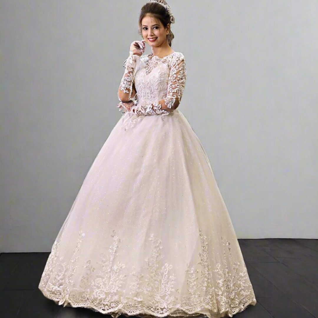 White Christian bridal dress with intricate lace bodice, illusion sleeves, and flowing tulle skirt