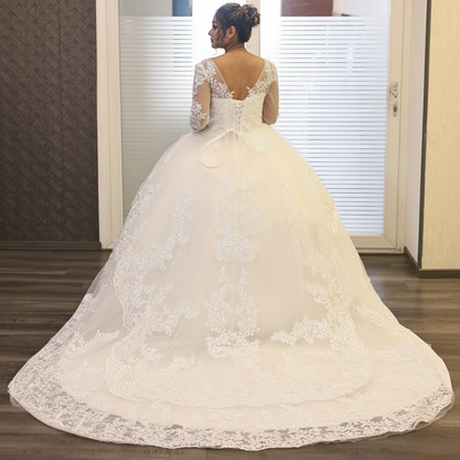 Luxury white Christian bridal gown featuring delicate lace appliqué and a voluminous layered skirt