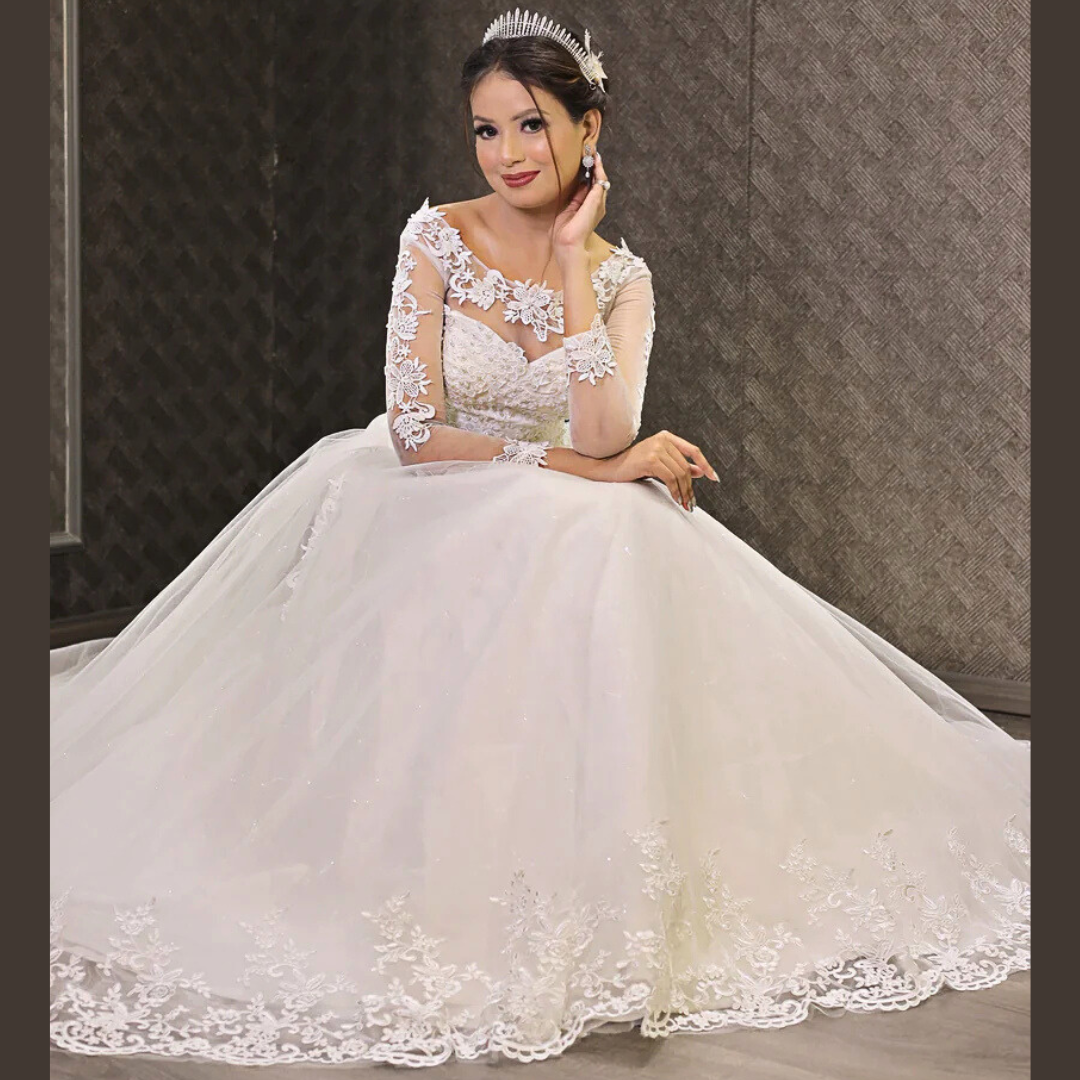 Modest Christian bridal dress with illusion neckline, lace sleeves, and a graceful ball gown silhouette