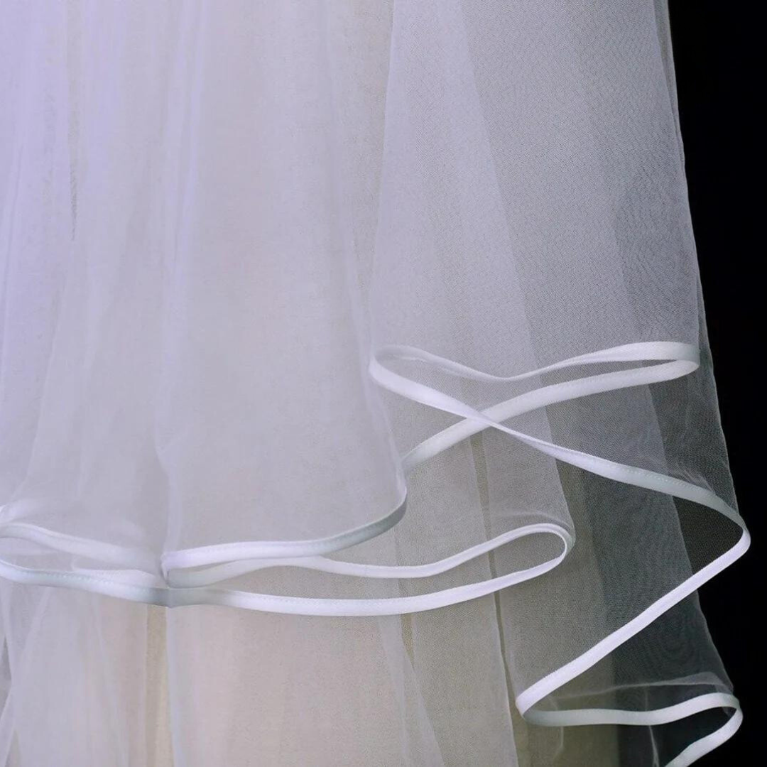 White bridal veil with elegant satin ribbon trim for church ceremony
