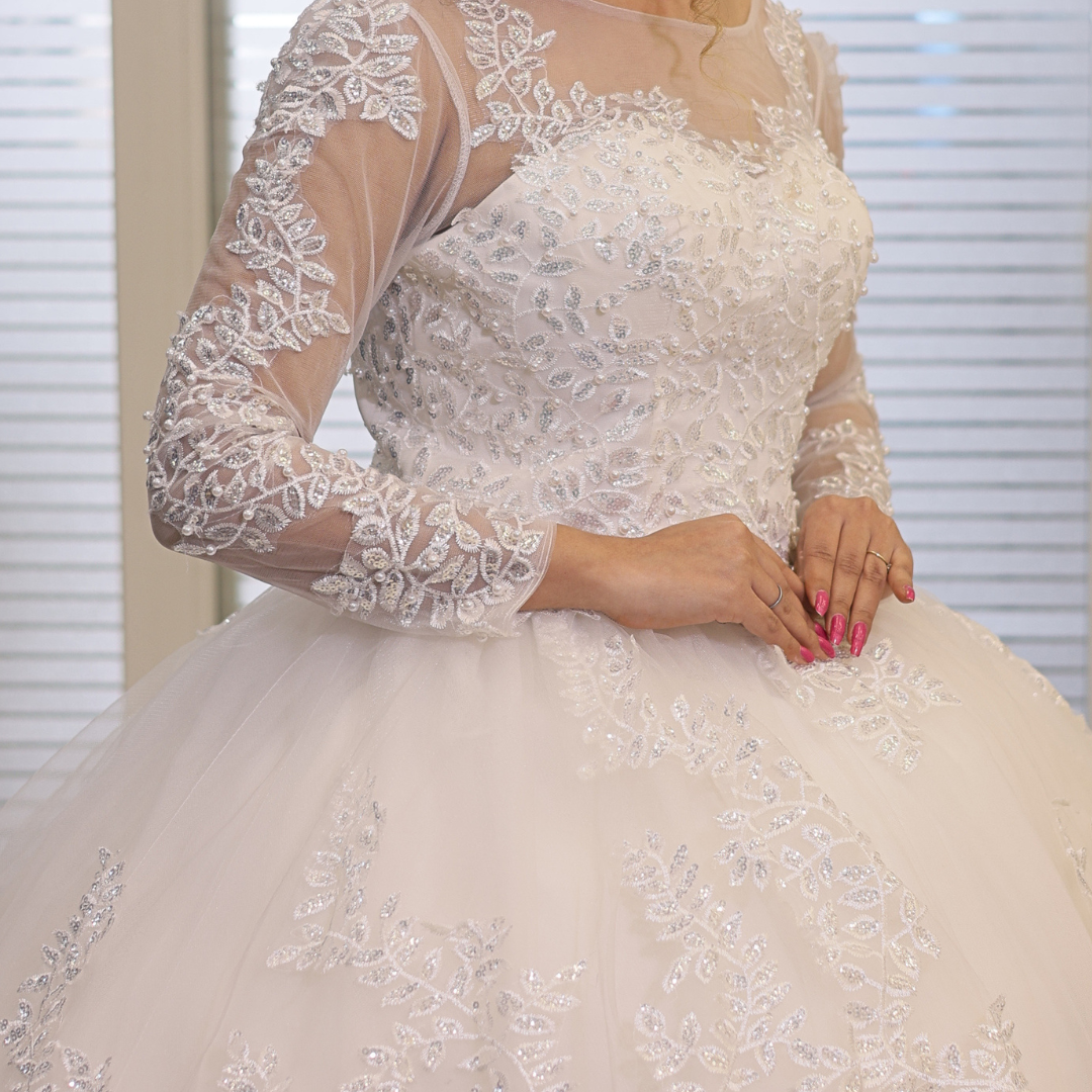 Premium church wedding gown by GownLink with layered lace skirt and elegant illusion sleeves