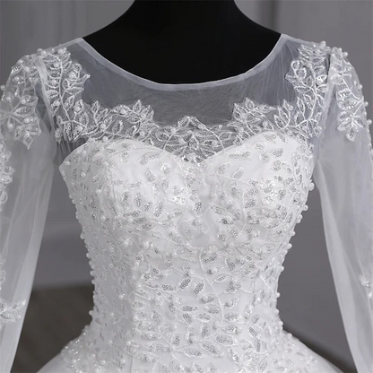 Timeless Christian lace wedding dress with illusion bodice and beautifully embroidered hemline