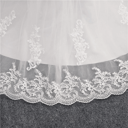 Timeless Christian lace wedding gown by GownLink with elegant long sleeves, floral embroidery, and a graceful bridal silhouette