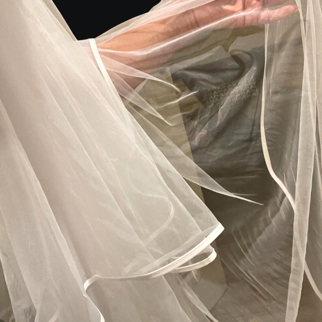 White bridal veil with long back layer and satin border for wedding day